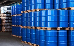 3 tiers of blue chemical drums sit on palettes in a warehouse