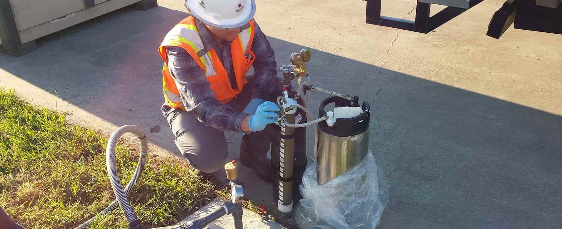 Person in hardhat and safety vest conducting remediation services