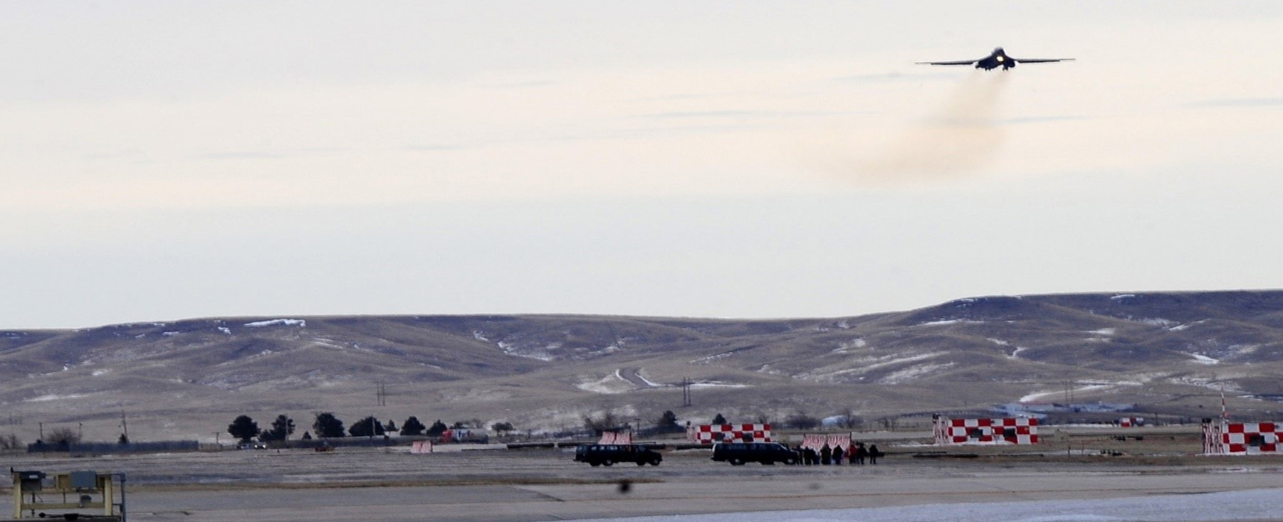 plane taking off over air force base