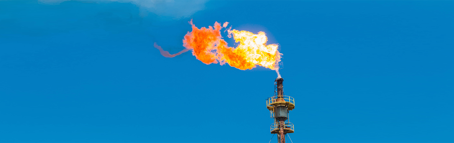 gas flare against clear blue sky