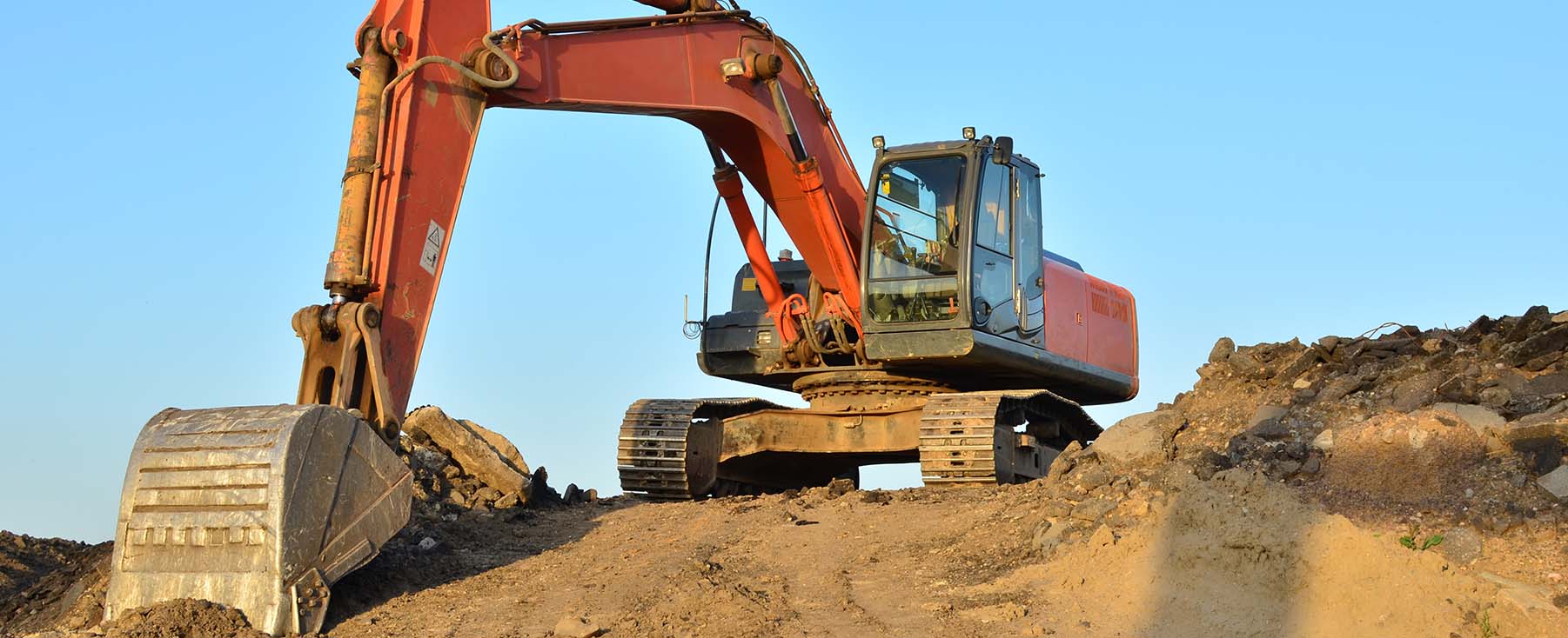 Excavator picking up soil