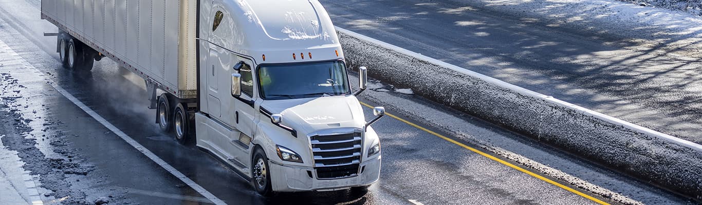 Truck driving on snowy highway