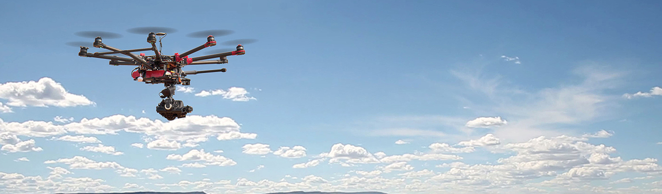 Drone flying against blue sky