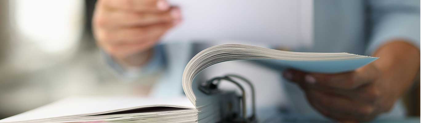 Woman reviewing binder of papers