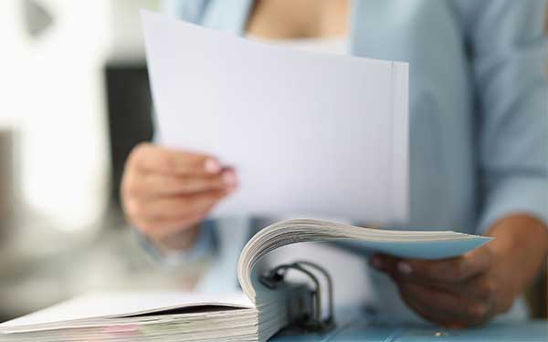 Women reviewing binder of papers