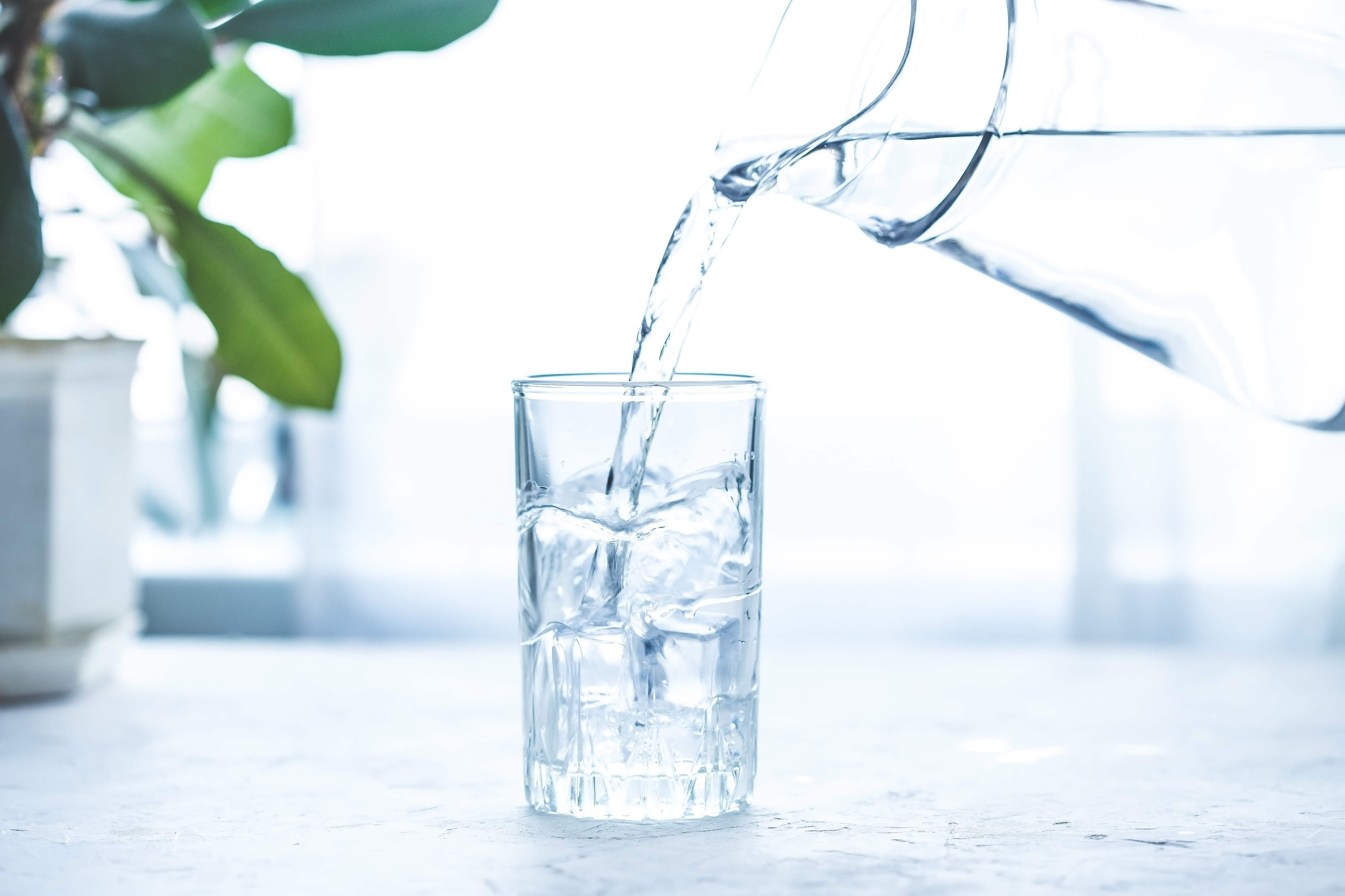 Drinking water pouring into a glass