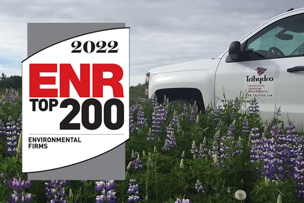 White Trihydro truck in lupine field