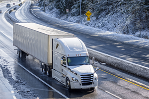 Truck driving on snowy highway