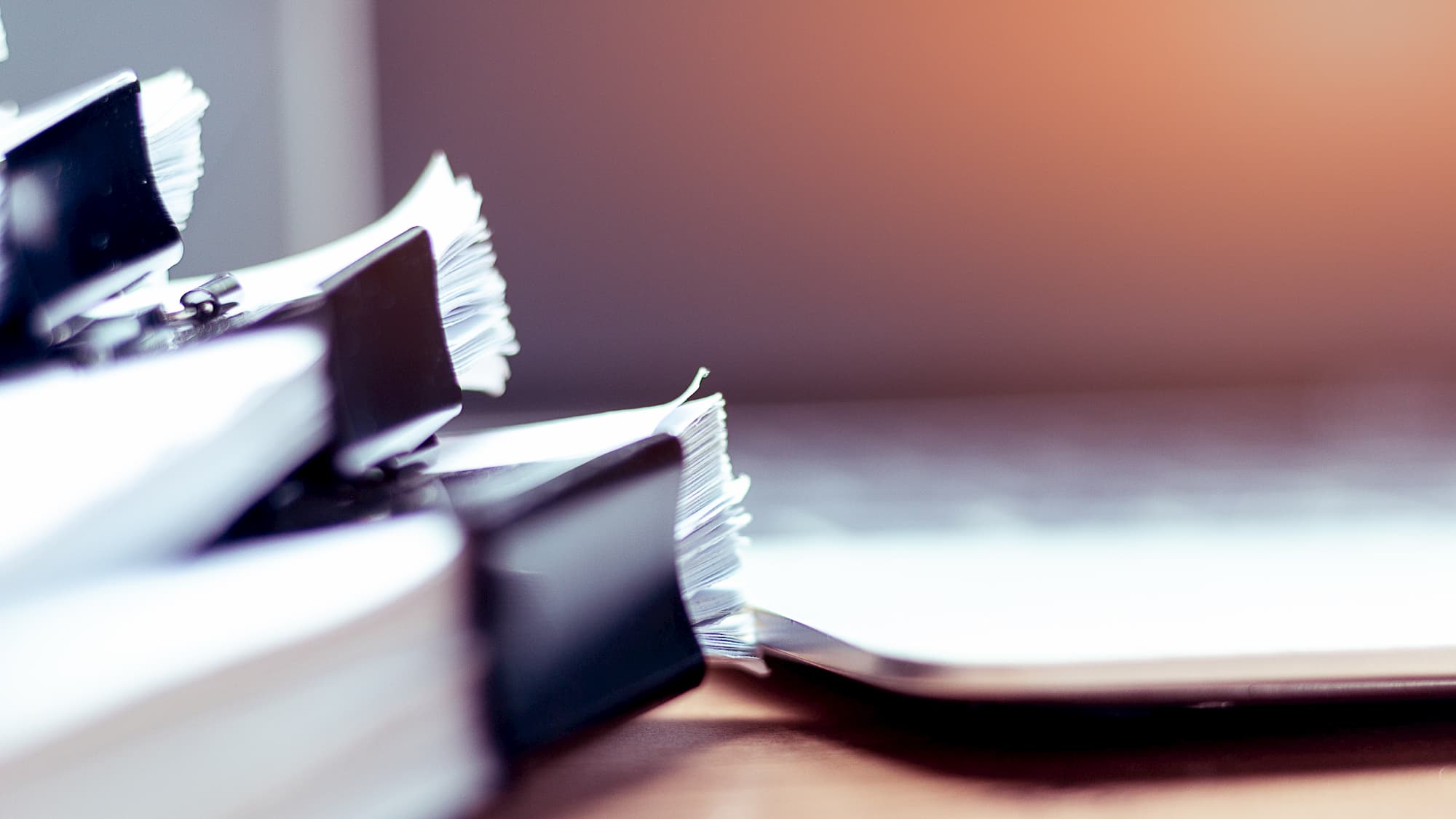 Stack of documents placed on a business desk in a business office